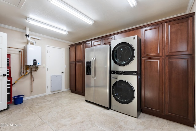 laundry area with tankless water heater, crown molding, and stacked washer and dryer