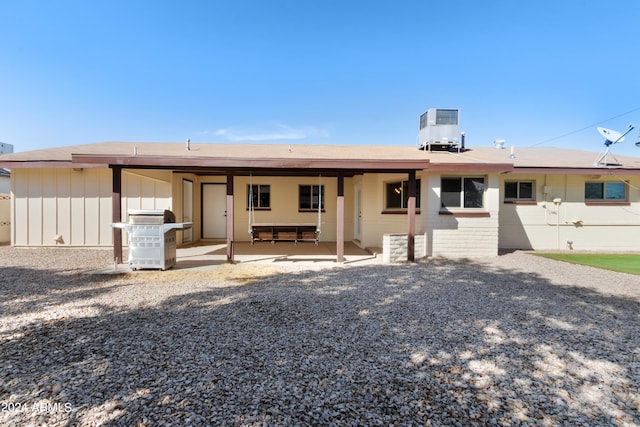 ranch-style house with central AC unit and a patio area