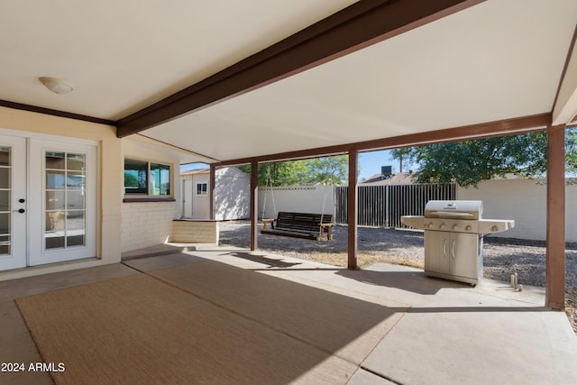 view of patio / terrace featuring a grill and a storage unit