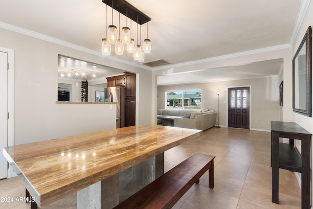 tiled dining space with crown molding