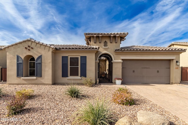 mediterranean / spanish-style house with a garage