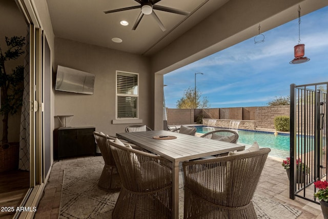 view of patio with a fenced in pool and ceiling fan