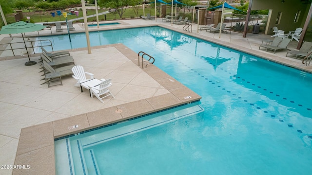 view of swimming pool featuring a patio area