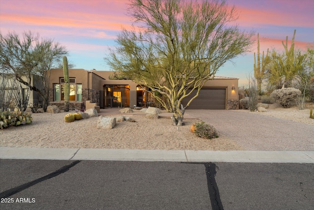 pueblo-style house featuring a garage