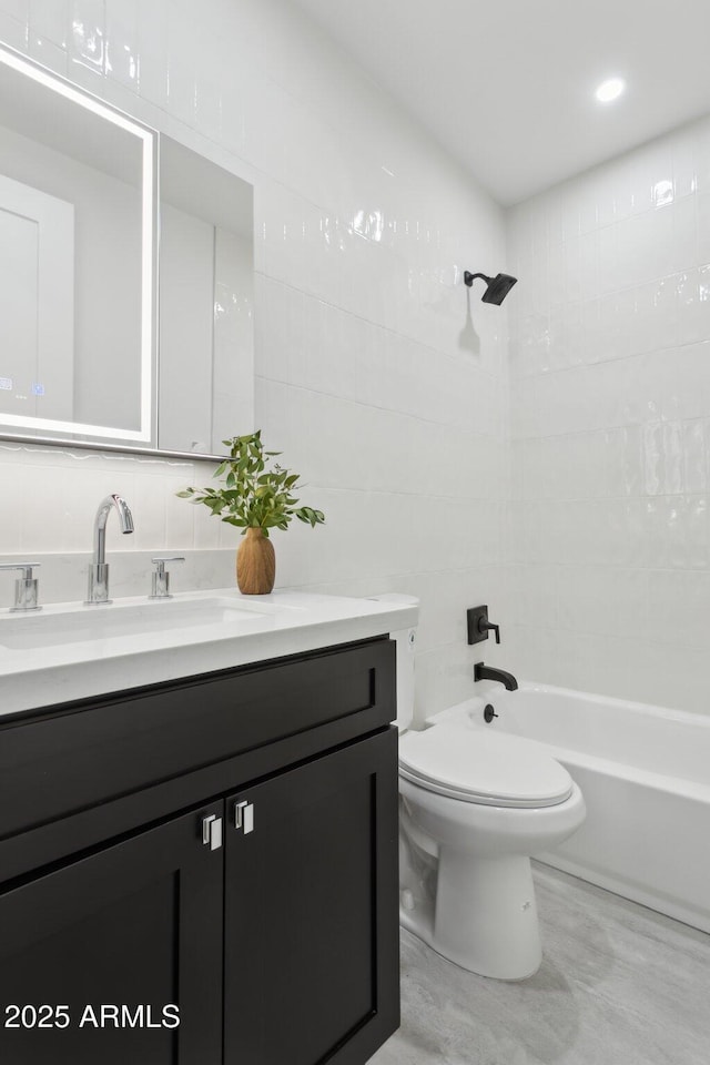 full bathroom with vanity, backsplash, toilet, and shower / bath combination