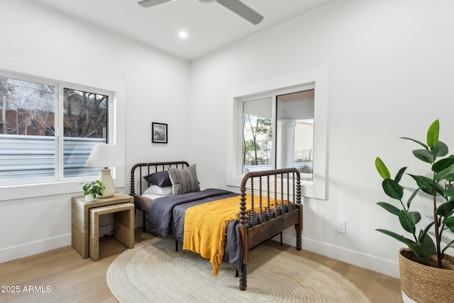 bedroom with ceiling fan and light wood-type flooring