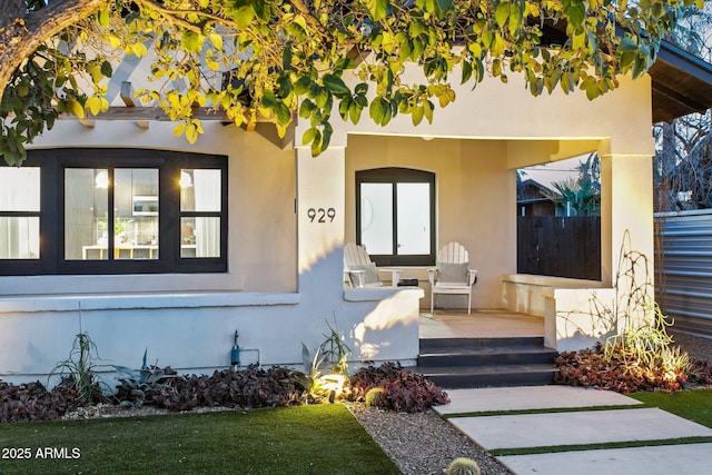 view of exterior entry featuring a patio area