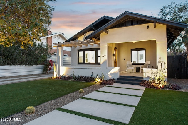 view of front of property with a yard and a patio