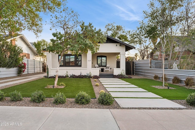 bungalow featuring a porch and a front lawn