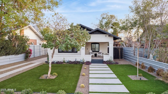 view of front of property with a front yard and a porch