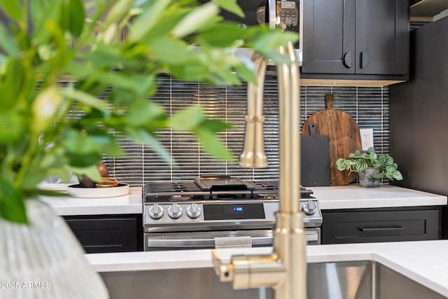 kitchen with decorative backsplash and stainless steel range with gas cooktop