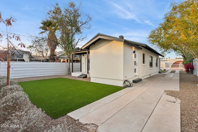 view of home's exterior with a yard