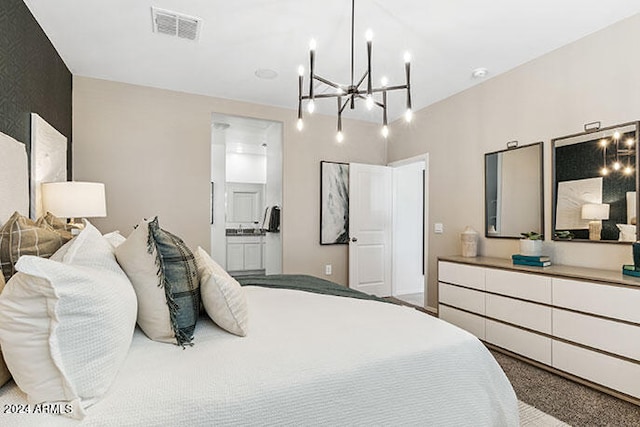 bedroom with ensuite bathroom and carpet floors