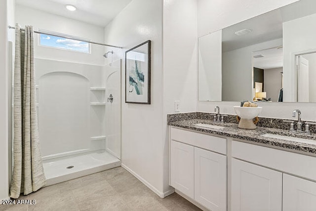 bathroom featuring vanity and curtained shower