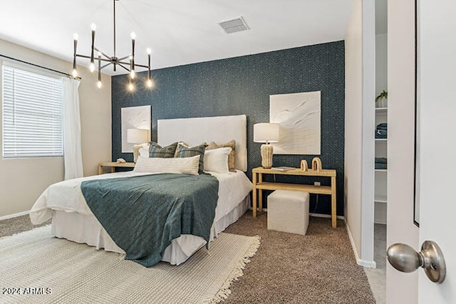 carpeted bedroom with a chandelier