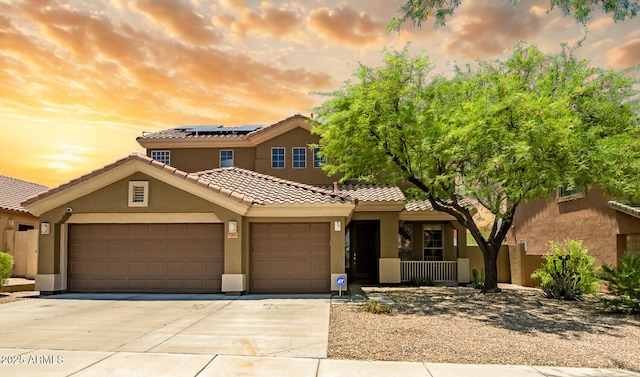 17493 W Arroyo Way, Goodyear, AZ 85338 - view of front of house featuring an attached garage, driveway, solar panels, and stucco siding