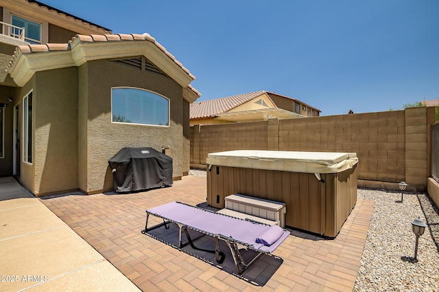 17493 W Arroyo Way, Goodyear, AZ 85338 - fenced backyard featuring a hot tub, a patio, and a grill