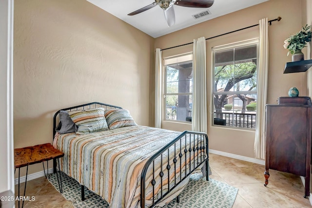 17493 W Arroyo Way, Goodyear, AZ 85338 - tiled bedroom with a ceiling fan and baseboards