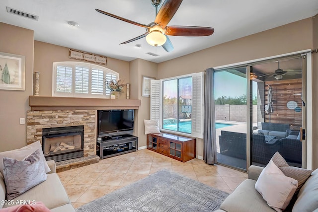 17493 W Arroyo Way, Goodyear, AZ 85338 - tiled living area featuring ceiling fan and a fireplace