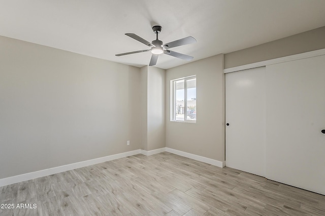 4509 E La Puente Ave, Phoenix, AZ 85044 - unfurnished bedroom featuring light wood-style flooring, a closet, baseboards, and ceiling fan