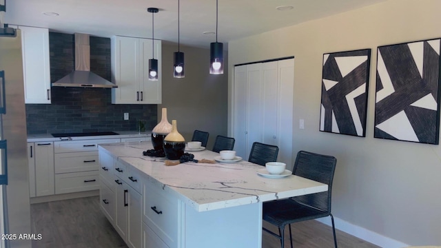 4509 E La Puente Ave, Phoenix, AZ 85044 - kitchen featuring wall chimney range hood, wood finished floors, black electric cooktop, white cabinetry, and recessed lighting