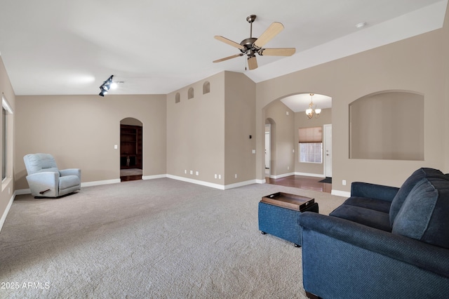 carpeted living room with vaulted ceiling and ceiling fan