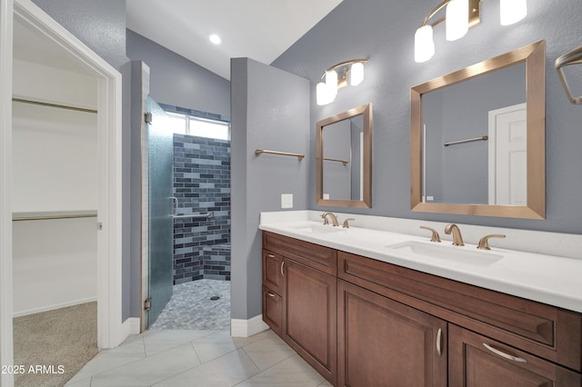 bathroom featuring walk in shower, tile patterned floors, vanity, and vaulted ceiling