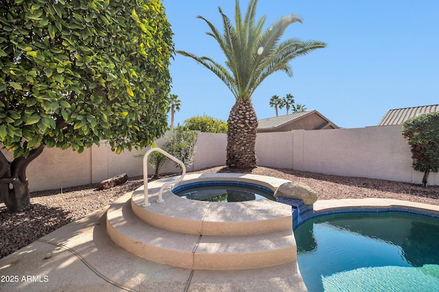 view of pool with an in ground hot tub