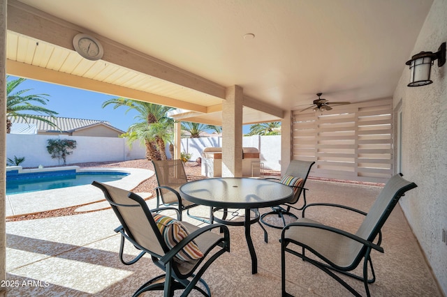 view of patio with a fenced in pool and ceiling fan