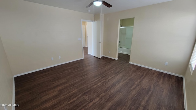 interior space with baseboards, dark wood finished floors, and a ceiling fan