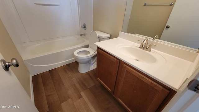 full bath featuring vanity, shower / bath combination, wood finished floors, and toilet