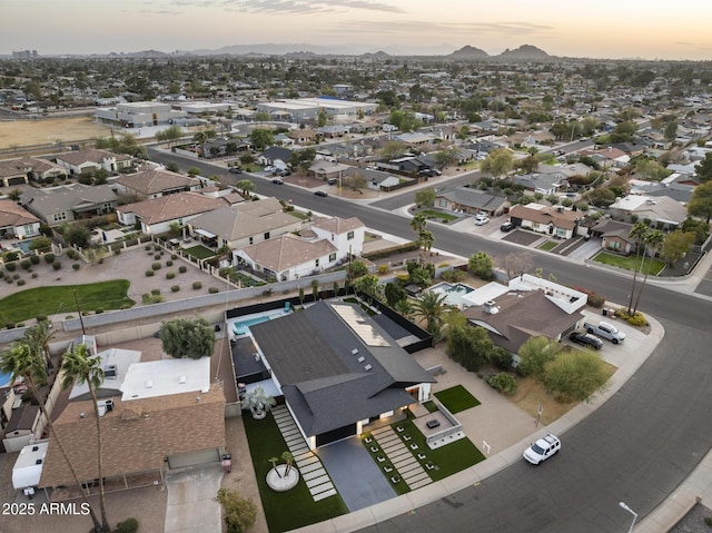 aerial view at dusk featuring a residential view