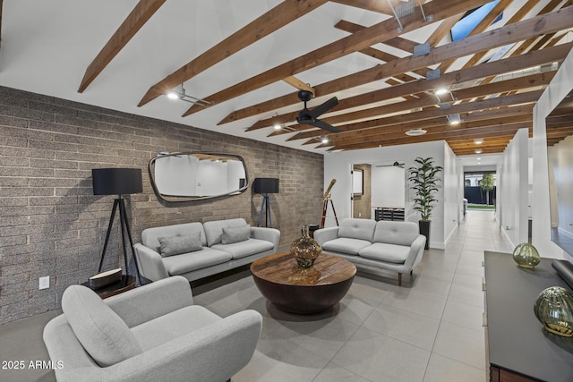 living room featuring light tile patterned floors, brick wall, and beamed ceiling