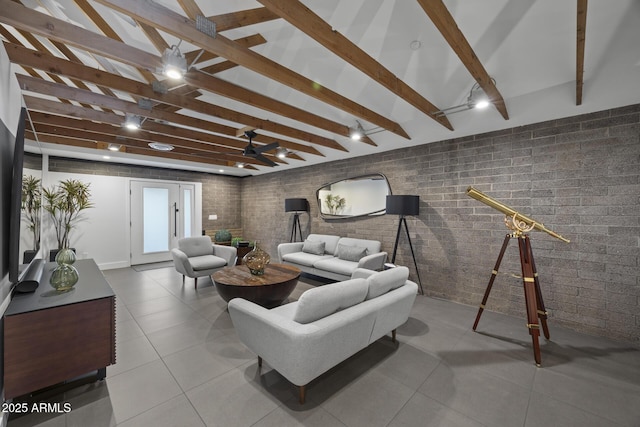 living room with tile patterned flooring, vaulted ceiling with beams, and brick wall