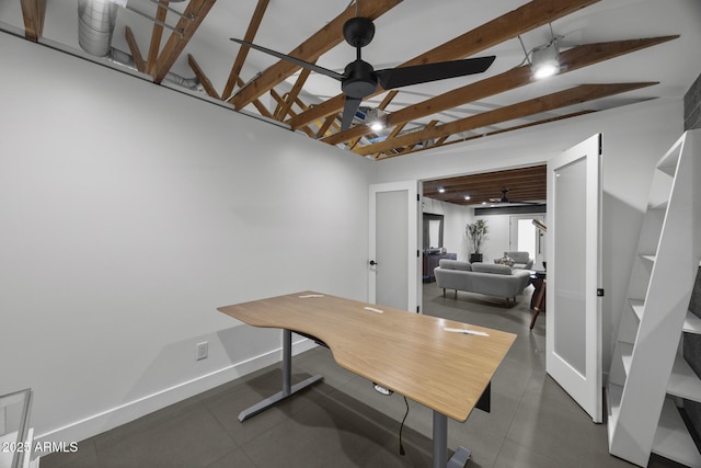 home office featuring vaulted ceiling with beams, ceiling fan, and baseboards