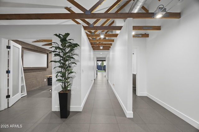 hallway featuring vaulted ceiling with beams, baseboards, and tile patterned floors