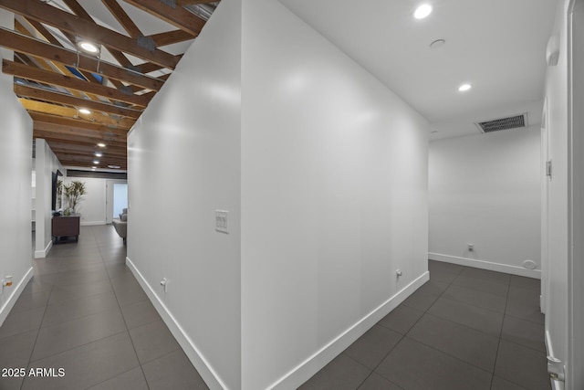 hall with baseboards, recessed lighting, visible vents, and tile patterned floors