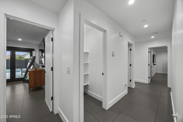 hallway featuring baseboards, dark tile patterned flooring, french doors, and recessed lighting