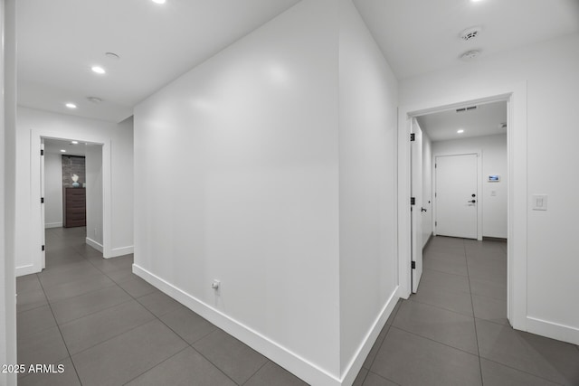 hall with baseboards, recessed lighting, visible vents, and tile patterned floors