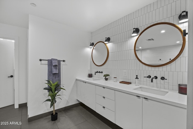 full bathroom featuring visible vents, tile patterned flooring, a sink, and tile walls