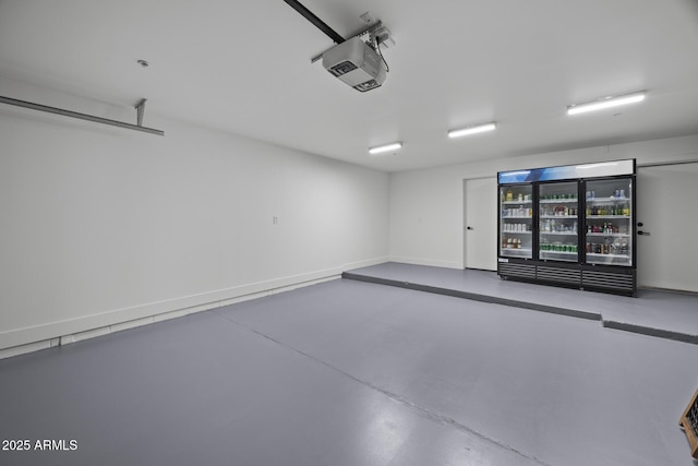 garage with a garage door opener and baseboards