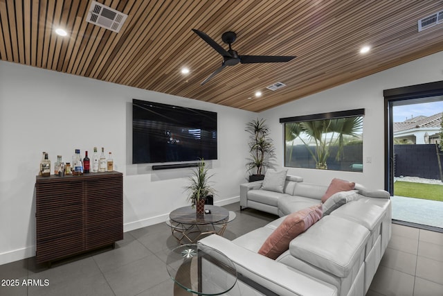 living area featuring lofted ceiling, visible vents, baseboards, and recessed lighting