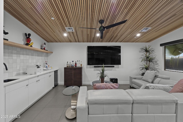 living room featuring ceiling fan, tile patterned flooring, visible vents, wood ceiling, and baseboards