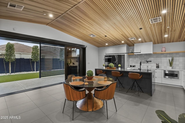 dining space with lofted ceiling, wood ceiling, visible vents, and tile patterned flooring