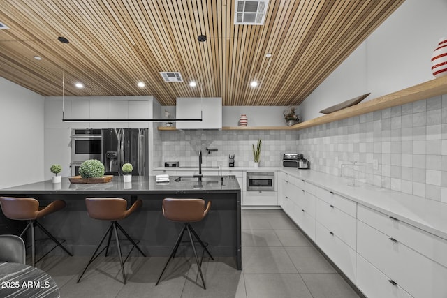 kitchen featuring visible vents, black refrigerator with ice dispenser, double oven, open shelves, and a sink