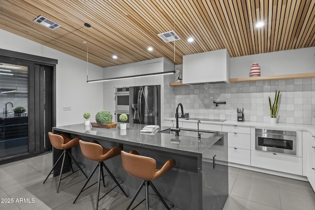 kitchen featuring wood ceiling, modern cabinets, fridge with ice dispenser, and visible vents