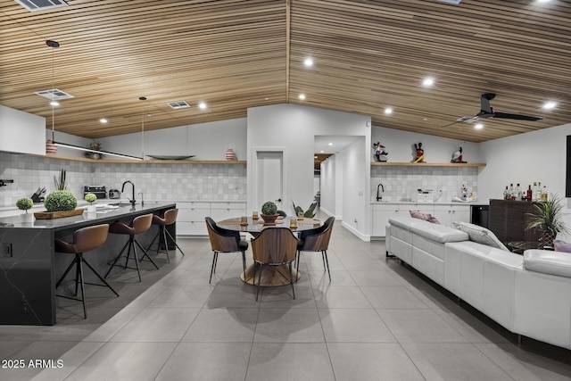 dining space featuring visible vents, wood ceiling, vaulted ceiling, bar, and tile patterned floors