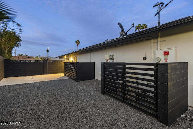 view of side of home with fence and stucco siding