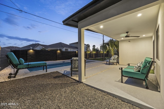 view of patio / terrace with a ceiling fan, a fenced in pool, and a fenced backyard