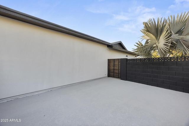 view of patio / terrace featuring fence